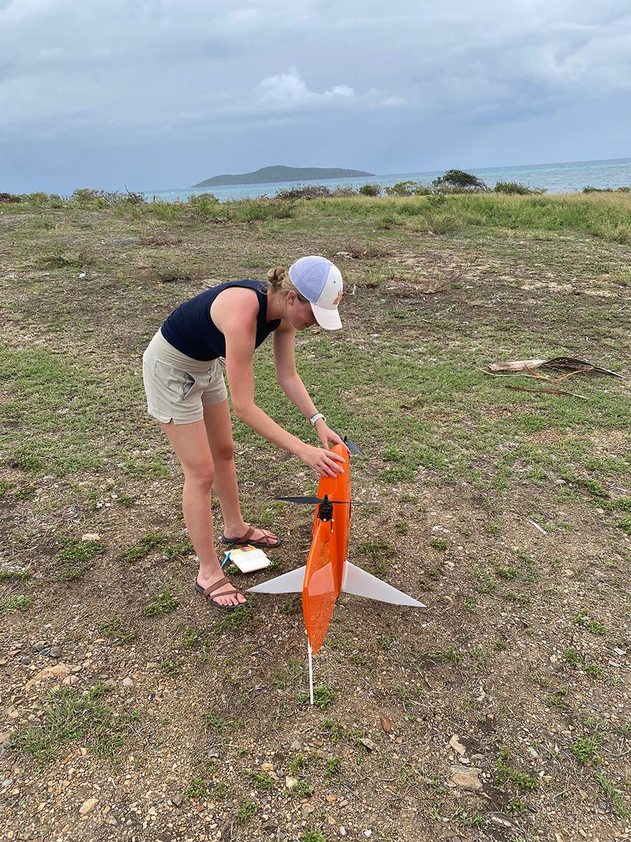 student preps drone for takeoff