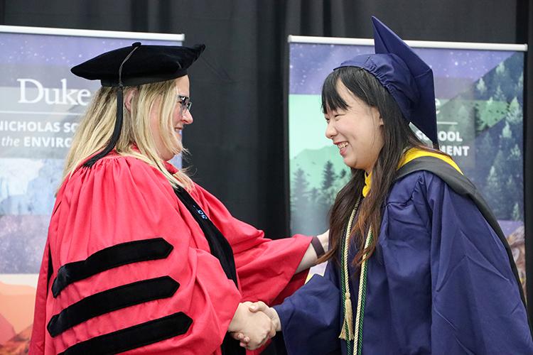 Dean Lori Bennear shakes hands with Finnie on stage