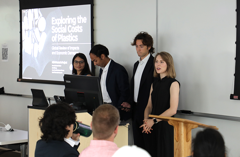 master's students giving their MP presentation on the Social Cost of Plastics