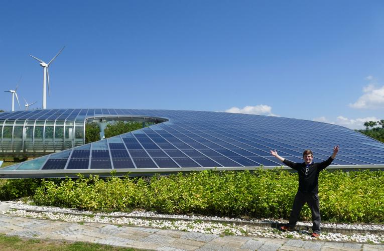 Student in front of a solar panel