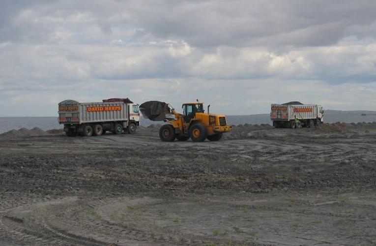 Trucks collecting coal ash