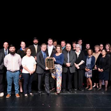 Duke President Vincent Price presents the Duke Presidential Team Award to the Duke Marine Lab Hurricane Response Team.