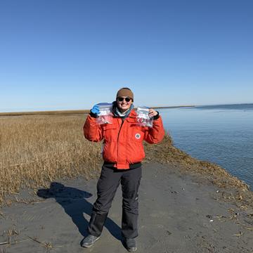 Maddie holding harbor seal scat samples collected at a haul out site in Virginia.